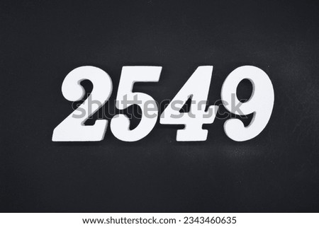 Black for the background. The number 2549 is made of white painted wood.