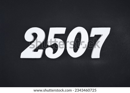 Black for the background. The number 2507 is made of white painted wood.