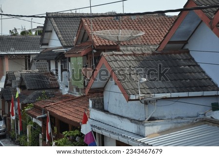 Aerial view of roofing work being done on a house. You can see cables and parabolas connected to people's houses Royalty-Free Stock Photo #2343467679