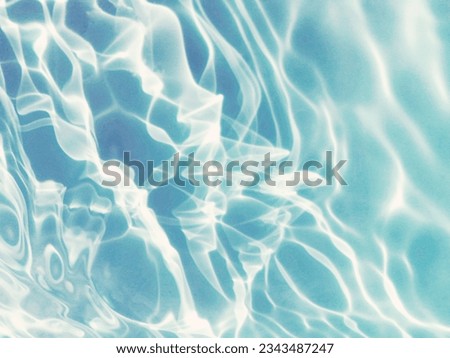 Closeup​ blur​ abstract​ of​ surface​ blue​ water. Abstract​ of​ surface​ blue​ water​ reflected​ with​ sunlight​ for​ background.Top​ view​ of blue​ water.​ Water​ splashed​ abstract​ background.