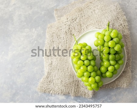 Shine Muscat, green grapes on a plate Royalty-Free Stock Photo #2343495757