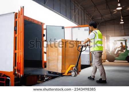 Workers Unloading Heavy Box into Container Truck. Trucks Loading Dock Warehouse. Supply Chain,  Package Boxes Shipment, Supplies Warehouse. Freight Truck Logistic, Cargo Transport, Warehouse Shipping. Royalty-Free Stock Photo #2343498385