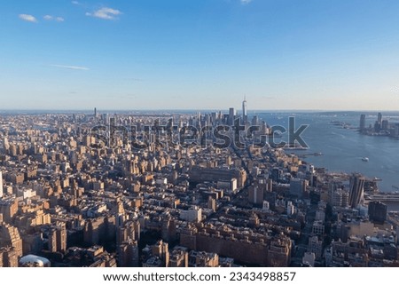 Captivating aerial view of New York City skyline over the Hudson River during the dusk seen from The Edge. Few white clouds above the city. Endless rows of tall buildings. Bustling and lively city Royalty-Free Stock Photo #2343498857