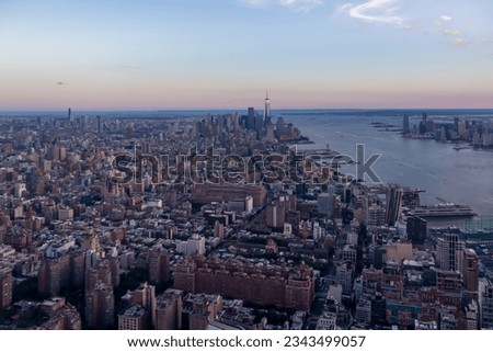 Captivating aerial view of New York City skyline over the Hudson River during the dusk seen from The Edge. Few white clouds above the city. Endless rows of tall buildings. Bustling and lively city