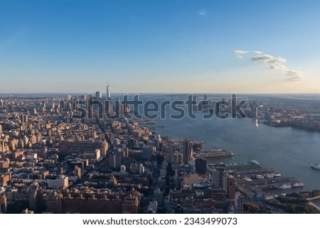 Captivating aerial view of New York City skyline over the Hudson River during the dusk seen from The Edge. Few white clouds above the city. Endless rows of tall buildings. Bustling and lively city Royalty-Free Stock Photo #2343499073