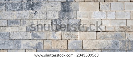 wide impressive old castle stone wall. Panoramic stone wall background for design with copy space. Royalty-Free Stock Photo #2343509563