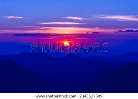 Scenic view dramatic beautiful sunset sky. Natural Sunset Sunrise on meadow silhouette shadow dark land. Vibrant dramatic sky on sunset, dawn, sunrise in Countryside. Landscape Colorful Sky At Sunset Royalty-Free Stock Photo #2343527589