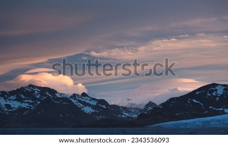 Last sunset light over mountains; South Georgia; Lenticular clouds at sunset; South Georgia