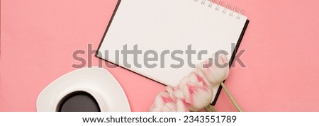 A beautiful bouquet of delicate pink tulips next to a cup of coffee on a pink background. There may be your text. Horizontal wide photo subtitle, cover. copy-space