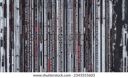 Railway station and freight train wagons with SKODA cars and different heavy load,aerial panorama landscape view,big railway station-winter time,colorful abstract patterns from wagons and locomotive Royalty-Free Stock Photo #2343555603