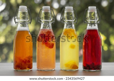 Homemade fermented raw kombucha tea with different flavorings. Healthy natural probiotic flavored drink. fermented kombucha tea. glass jar. glass and bottle. Copy space. Royalty-Free Stock Photo #2343569427
