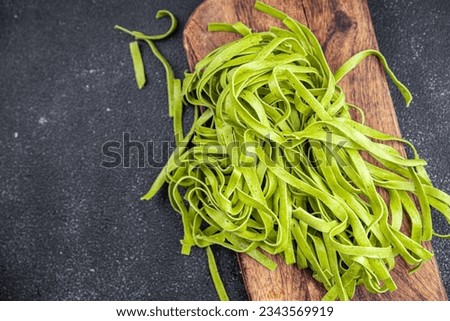 tagliatelle green color raw pasta basil vegetable food healthy meal food snack on the table copy space food background rustic top view