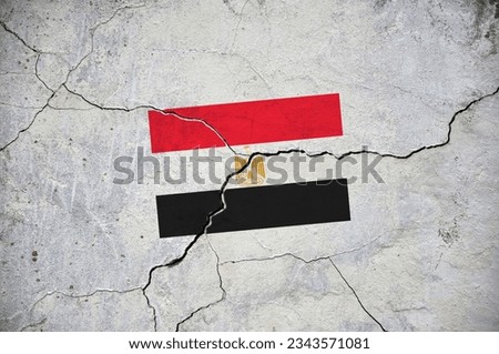 An old image of the flag of Egypt on a wall with a crack. A crisis.