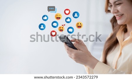 Woman using smartphone sending emojis. Happy woman using phone to chat online with friends. 3d emoji icon. Royalty-Free Stock Photo #2343572279