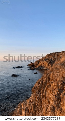 Photo of a cove with sunset in summer. (Crique du Porteils)
