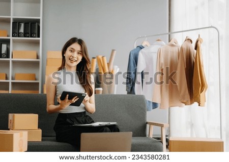 Young business owner woman prepare parcel box and standing check online orders for deliver to customer on tablet, laptop Shopping Online concept.
 Royalty-Free Stock Photo #2343580281
