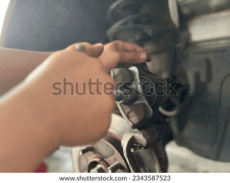 Installing pistons in car brakes with a pressure device Royalty-Free Stock Photo #2343587523