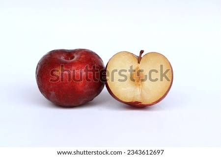 Close up image of red plum fruit and sliced plum isolated on white background
