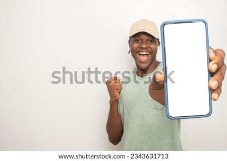 yong black man showing his phone screen rejoices Royalty-Free Stock Photo #2343631713