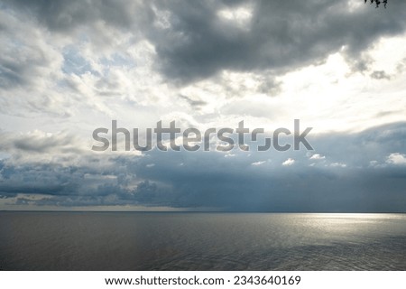 Luminous sunrise over the sea horizon, Baltic Sea, cloudy sky, blue water