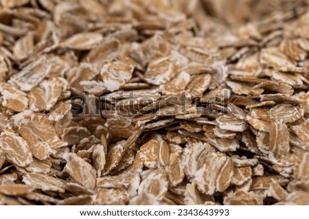 a bunch of fresh dry oatmeal flakes for making porridge, a large number of large oatmeal flakes for making breakfast Royalty-Free Stock Photo #2343643993