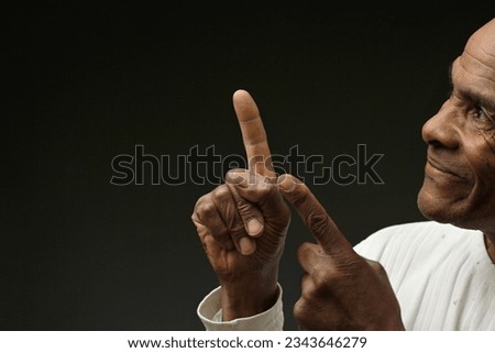 man pointing his finger with dark background with people stock photo