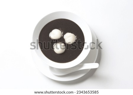 chef cook thick black sesame sweet soup with peanut glutinous rice ball 3pcs tang yuan in white bowl hot sweet asian festive traditional dessert halal food vegan menu for Hong Kong cafe Royalty-Free Stock Photo #2343653585
