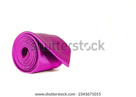 plain purple tie rolled isolated on white background close up shot single object concept copy space for texting and commercial usage 