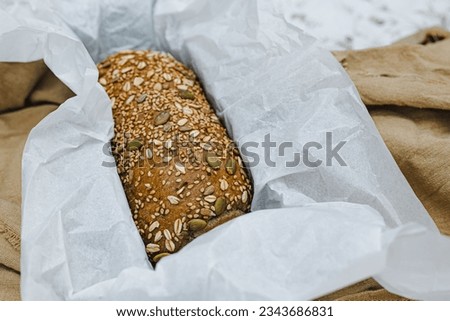Handmade organic bread with nuts, carefully arranged on the table, bakery products, natural food, healthy eating, low fat and sugar, rattan bread basket, bakery industry and packaging, delicateproduct