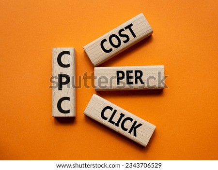 CPC - Cost Per Click symbol. Concept word AGM on wooden cubes. Beautiful orange background. Business and AGM concept. Copy space.