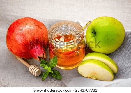Rosh Hashanah. Pomegranate, apple and honey, traditional food for Jewish New Year celebration.