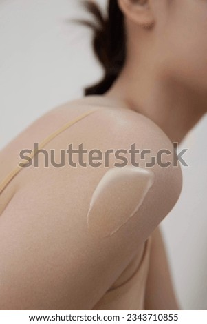 Apply cream to arm and shoulder skin care products Royalty-Free Stock Photo #2343710855