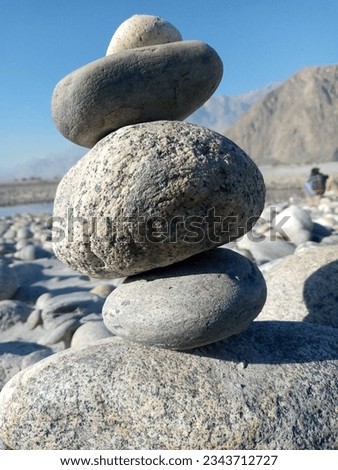 Small round rocks stacked up on each other