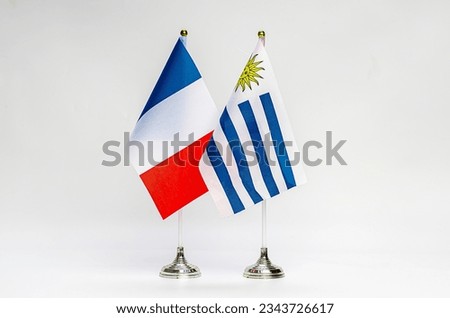 State flags of France and Uruguay on a light background. Flags.