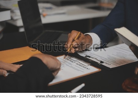 
Business and lawyers discussing contract papers with brass scale on desk in office. Law, legal services, advice, justice and law concept picture with film grain effect