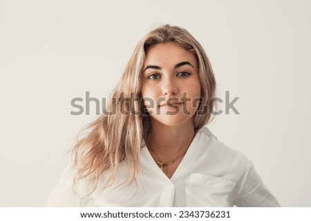 Close up overjoyed woman laughing, sitting on couch at home, head shot portrait young female chatting online with friends or relatives, looking at camera, having fun, making call or shooting video Royalty-Free Stock Photo #2343736231
