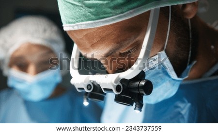 Cardiac Surgeon with surgical headlamp operates at a Heart Stent Royalty-Free Stock Photo #2343737559