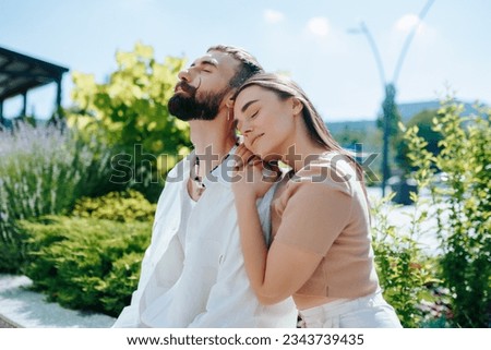 This enchanting image portrays a young couple deeply in love, enjoying a romantic outing together outside, creating beautiful memories in each other's company.