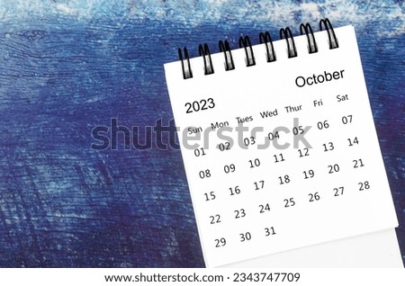 October 2023 Monthly desk calendar for 2023 year on old blue wooden background. Royalty-Free Stock Photo #2343747709