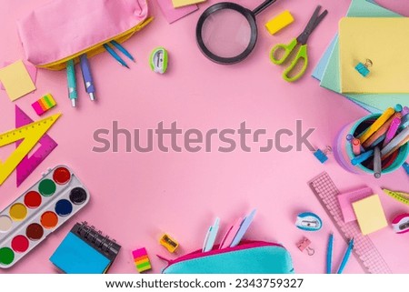 School equipment high-colored bright pink flat lay. Various school education and office supplies, accessories. Back to school sale background top view copy space