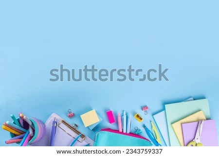 School equipment high-colored bright blue flat lay. Various school education and office supplies, accessories. Back to school sale background top view copy space