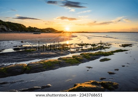 Low Hauxley Beach Sunset, nestled in between Amble and Druridge Bay its popular with walkers and at low tide the sandy beach is quite wide Royalty-Free Stock Photo #2343768651
