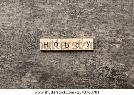 HOBBY word written on wood block. HOBBY text on cement table for your desing, concept.