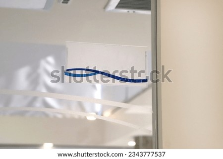 Indicator billboard on building wall, elevator door, office. Signal sign with copy space at the entrance of a door of an office or doctor's office.