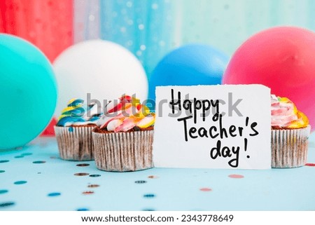 Happy teacher's day - celebration card with colorful cupcake and air balloons on blue background,  education profession holidays