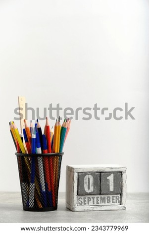 Organizer with pencils and ruler, stationery stand and wooden calendar with date September 01