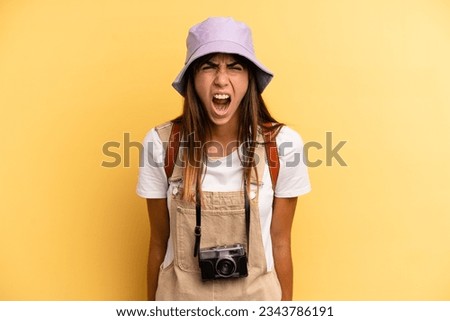 pretty woman shouting aggressively, looking very angry. tourist photographer concept