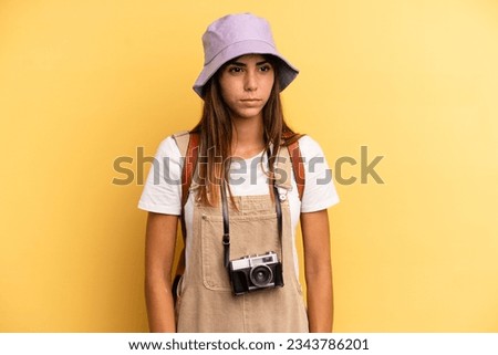 pretty woman feeling sad, upset or angry and looking to the side. tourist photographer concept