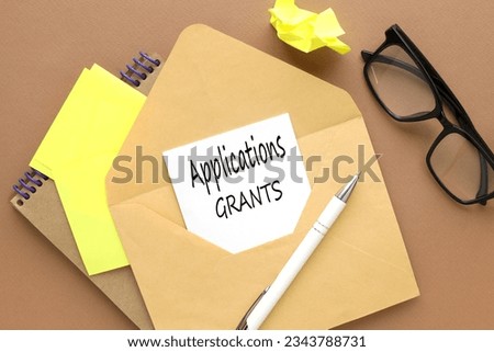 note paper with text.on the envelope.words Applications and Grants