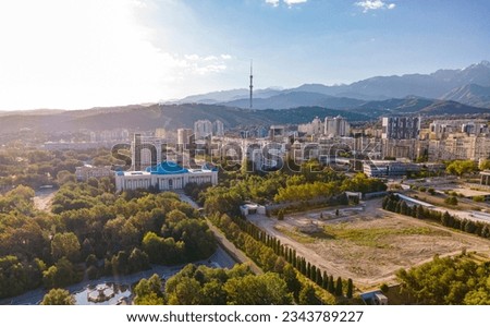 03 August 2023 Almaty Kazakhstan. The landscape of the city of Almaty from a height . Aerial photography of the city. Modern buildings, old buildings and high mountains.